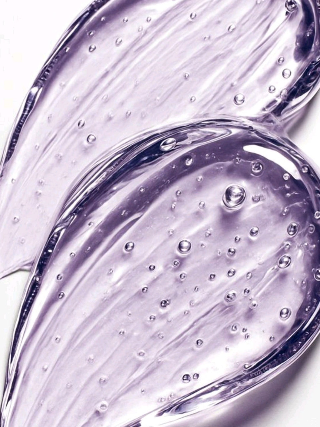 Close-up of purple gel with bubbles on a white background Grapes gel moisturizer- Fella Beauty 